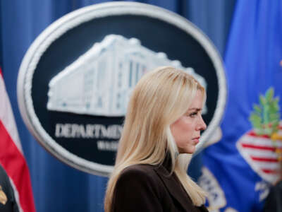 Attorney General Pam Bondi listens during a news conference at the Department of Justice Building on February 12, 2025, in Washington, D.C.