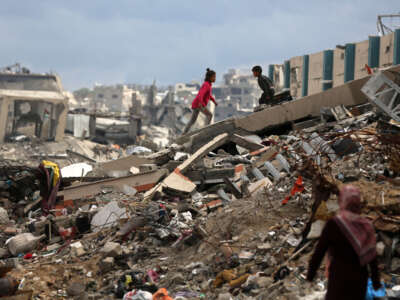 Palestinians walk past tents lining the streets amid the rubble of destroyed buildings in Jabalia, in the northern Gaza Strip, on February 21, 2025.