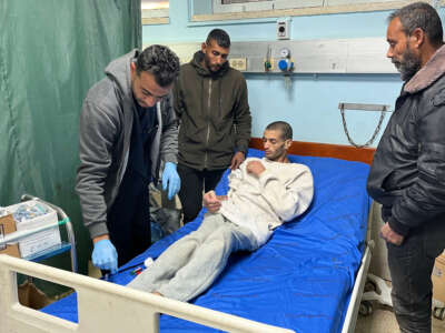 A Palestinian prisoner speaks with doctors at the European Hospital in Khan Yunis in the southern Gaza Strip early on February 27, 2025, following his release by Israeli authorities.