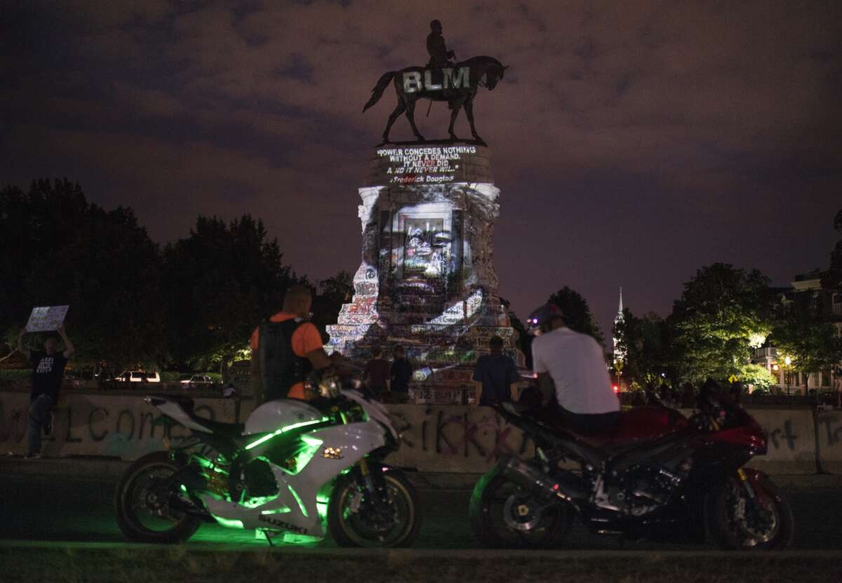 An image of Frederick Douglass is projected onto the Robert E. Lee Statue on Monument Avenue in Richmond, Virginia, on June 18, 2020.