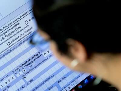 A person begins the process of filling out a passport application with an X gender marker, at their home in Alexandria, Virginia, on April 11, 2022.