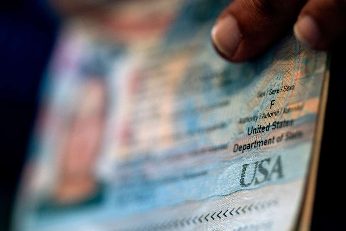 A person shows the Female gender marker on their current US passport, prior to beginning the process of filling out a passport application with an X gender marker, at their home in Alexandria, Virginia, on April 11, 2022.