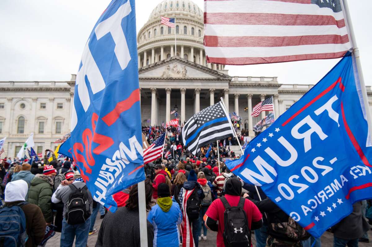 Trump flags fly as rioters take over the steps of the Capitol on January 6, 2021.