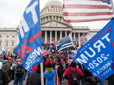 Trump flags fly as rioters take over the steps of the Capitol on January 6, 2021.