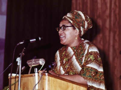 Audre Lorde talking on microphone at The Phillis Wheatley Poetry Festival.