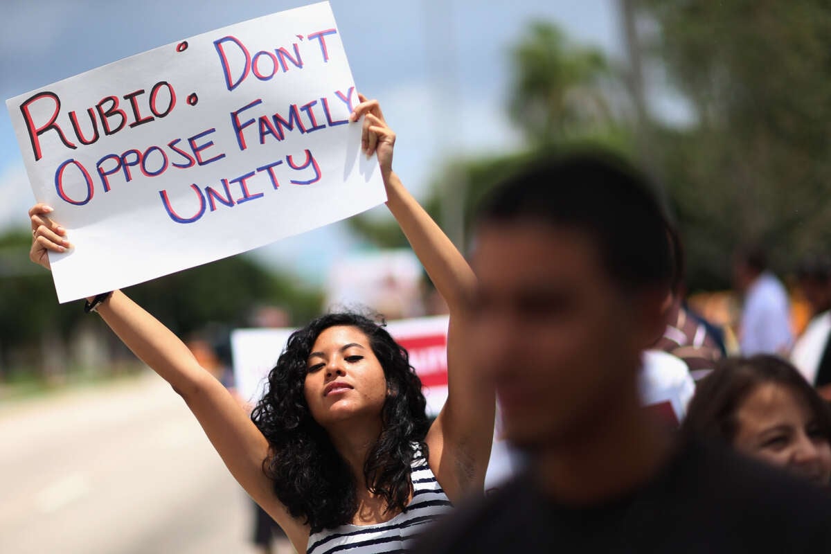 Mariana Rivas holds a sign reading, "Rubio: Don't Oppose Family Unity," as she joins with others in front of then-Sen. Marco Rubio's office on May 22, 2013, in Doral, Florida. The protesters were asking Rubio to stop opposing the inclusion of lesbian, gay, bisexual and transgender families in the Senate’s comprehensive immigration reform bill.