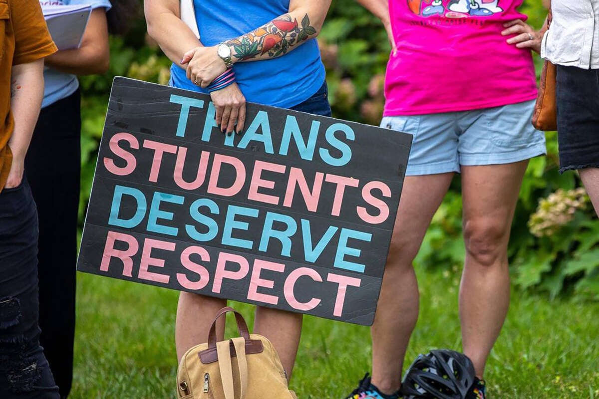 More than a dozen people attend a rally in support of trans youth in schools on June 26, 2023, outside the Fayette County Public Schools central office in Lexington, Kentucky.