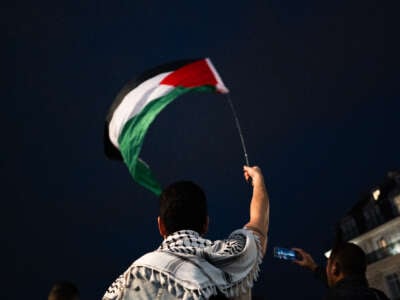 Protesters with flags attend a demonstration in support of Palestinian and Lebanese people as intense Israeli attacks occur in Gaza and Lebanon, in Paris, France, on October 25, 2024.