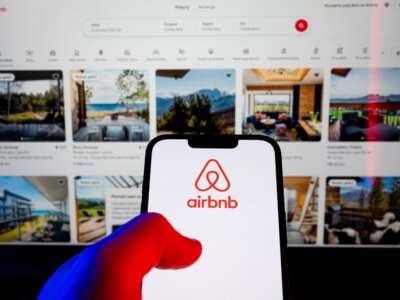 In this photo illustration, an Airbnb logo is displayed on a smartphone.