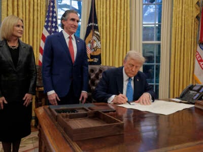 U.S. President Donald Trump signs Interior Secretary Doug Burghum's commission with Burgum and his wife Kathryn Burgum in the Oval Office on January 31, 2025 in Washington, DC. Trump spoke to reporters about tariffs against China, Canada and Mexico.