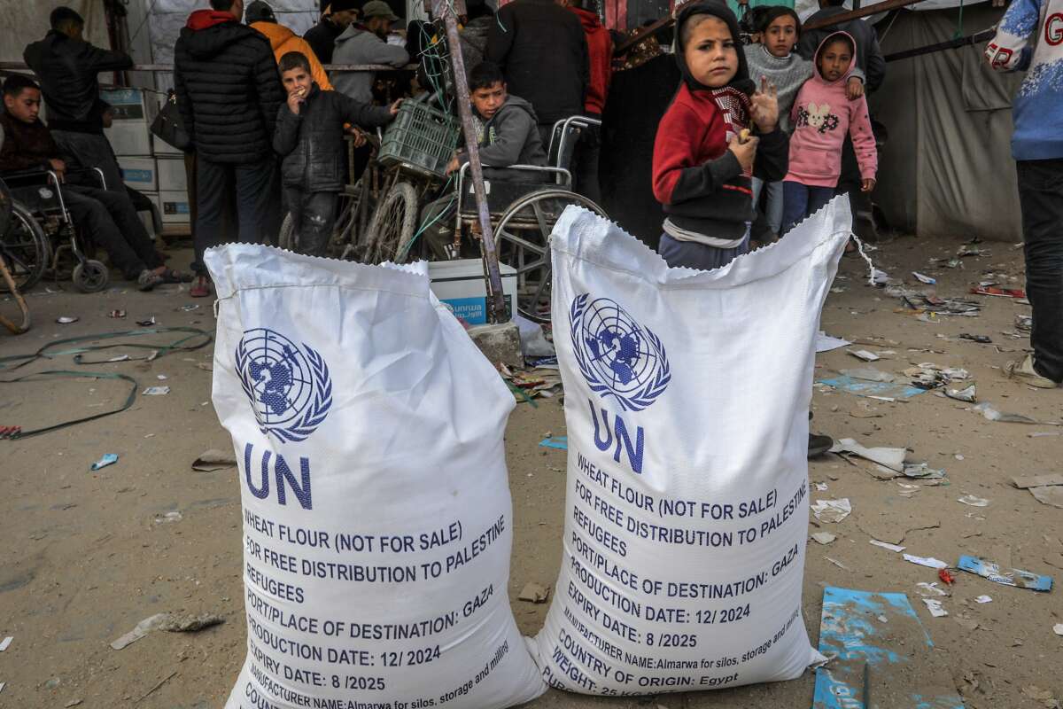 Palestinians receive humanitarian aid from the United Nations Relief and Works Agency for Palestine Refugees in the Near East (UNRWA) in Khan Younis.