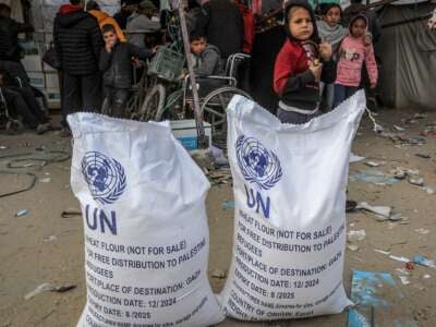 Palestinians receive humanitarian aid from the United Nations Relief and Works Agency for Palestine Refugees in the Near East (UNRWA) in Khan Younis.