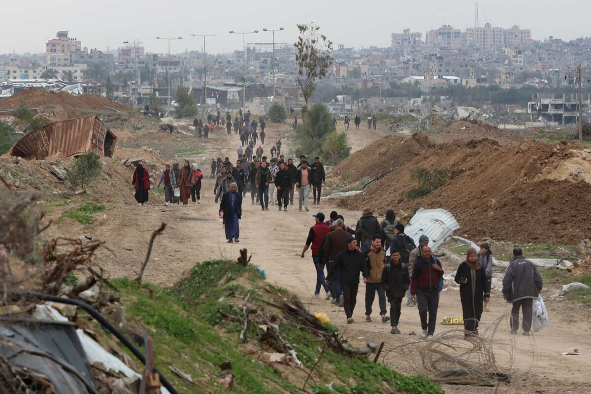 Displaced Palestinians cross the Netzarim Corridor as they make their way to the northern parts of the Gaza Strip on February 9, 2025.