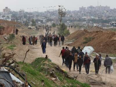 Displaced Palestinians cross the Netzarim Corridor as they make their way to the northern parts of the Gaza Strip on February 9, 2025.