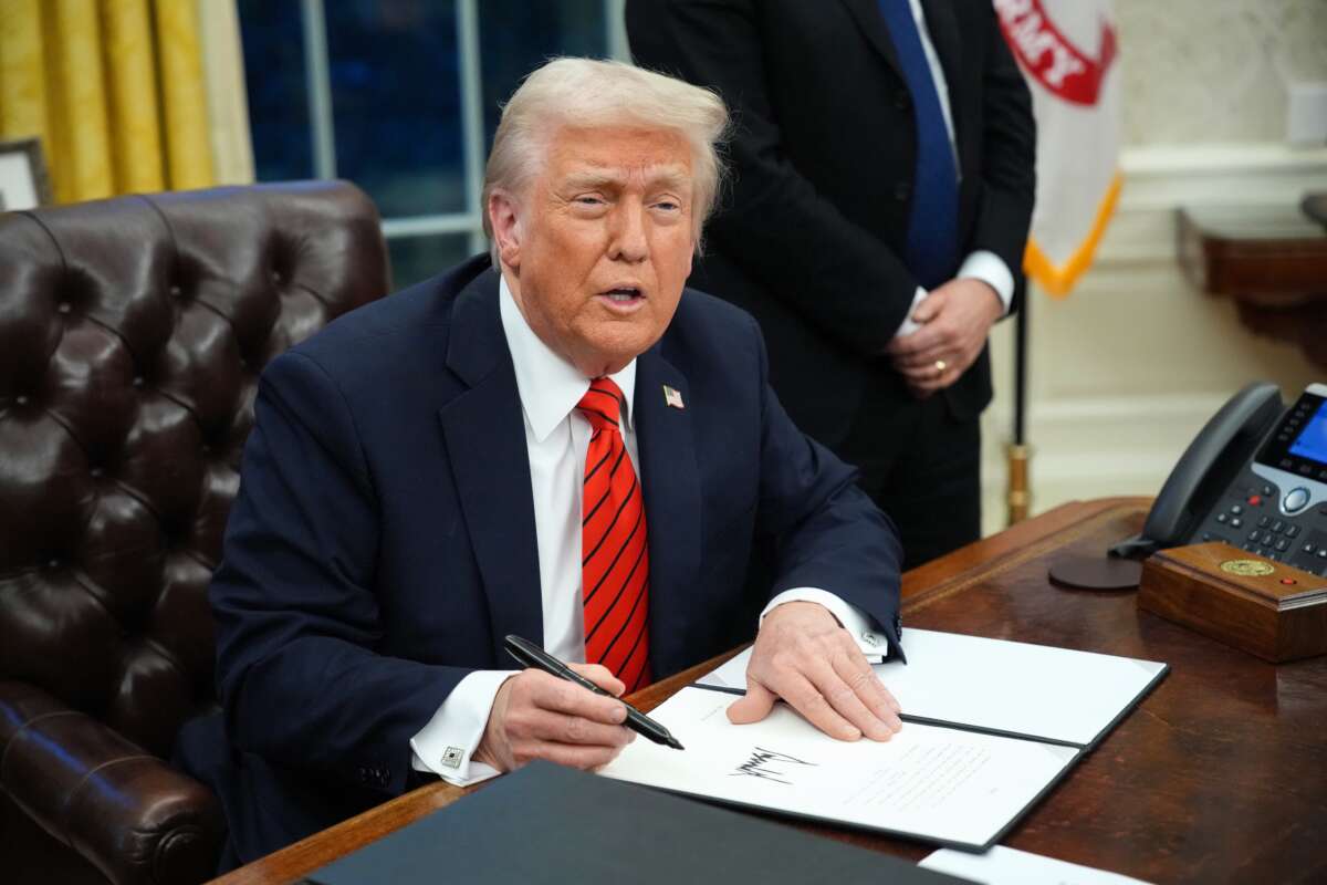 Donald Trump signs a series of executive orders in the Oval Office at the White House on February 10, 2025, in Washington, D.C.