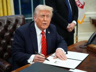 Donald Trump signs a series of executive orders in the Oval Office at the White House on February 10, 2025, in Washington, D.C.