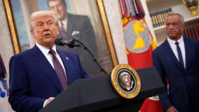 Donald Trump speaks alongside Robert F. Kennedy Jr. before Kennedy is sworn in as secretary of Health and Human Services in the Oval Office at the White House on February 13, 2025, in Washington, D.C.