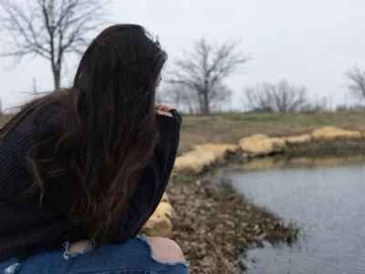 A North Texas woman, shown here gazing out at a small pond near her home in early February 2025, is afraid to discuss her abortion with her mental health therapist for fear she’ll be reported to authorities under Texas’ stringent abortion laws. The woman asked not to be identified for fear of repercussions.