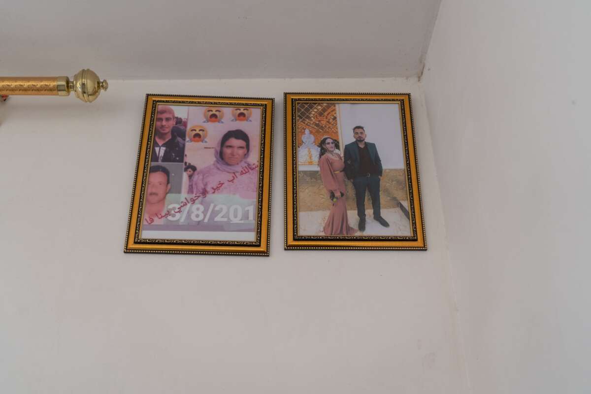 Photos hang on the wall of Shamo's parents and brothers, who are still missing and believed to have been killed by the Islamic State.