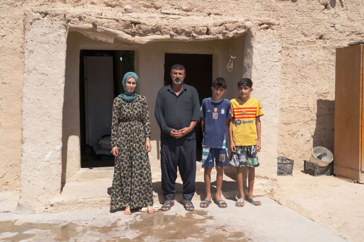 Amy Hussein stands with his wife and two sons.