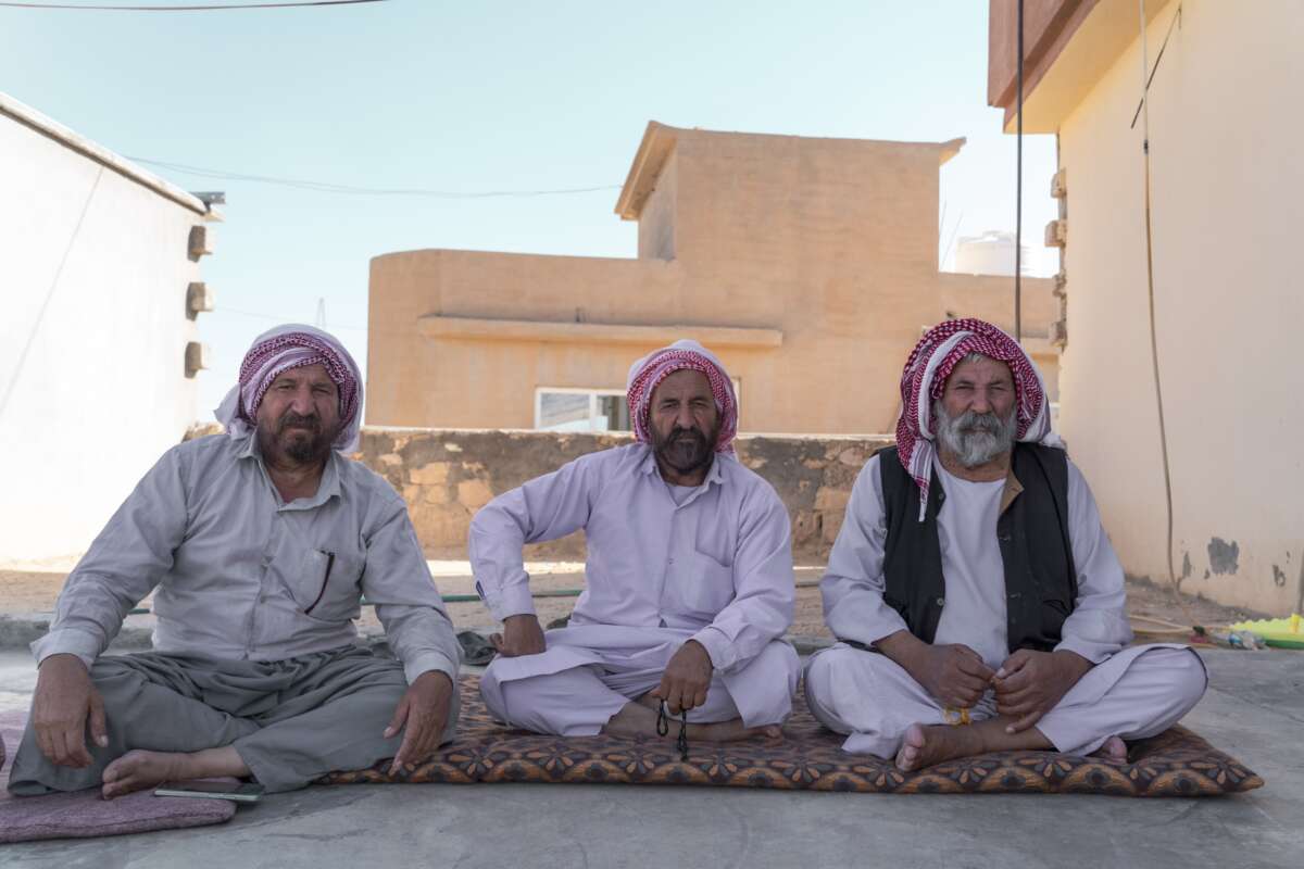 Omar Uso (right) sits beside his two sons at his home in Sinjar. 