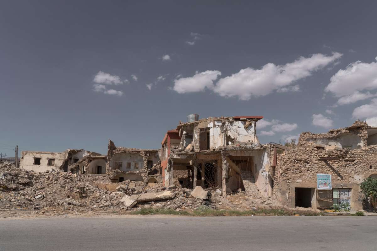 the shell of a building stands out against rubble.