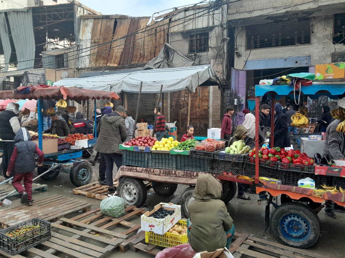 People shop at an outdoor market