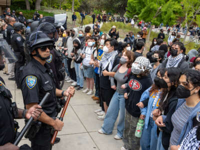 Pro-Palestinian protesters stand off with police during a rally on the campus of UCLA in Los Angeles on May 23, 2024.