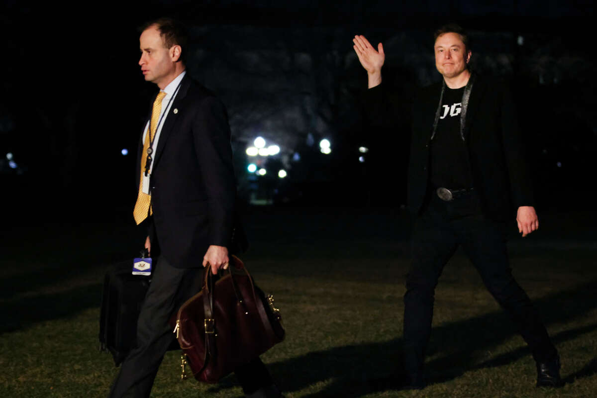 Staff Secretary Will Scharf (left) and White House Senior Advisor Elon Musk walk to the White House after landing in Marine One on the South Lawn on March 9, 2025, in Washington, D.C.