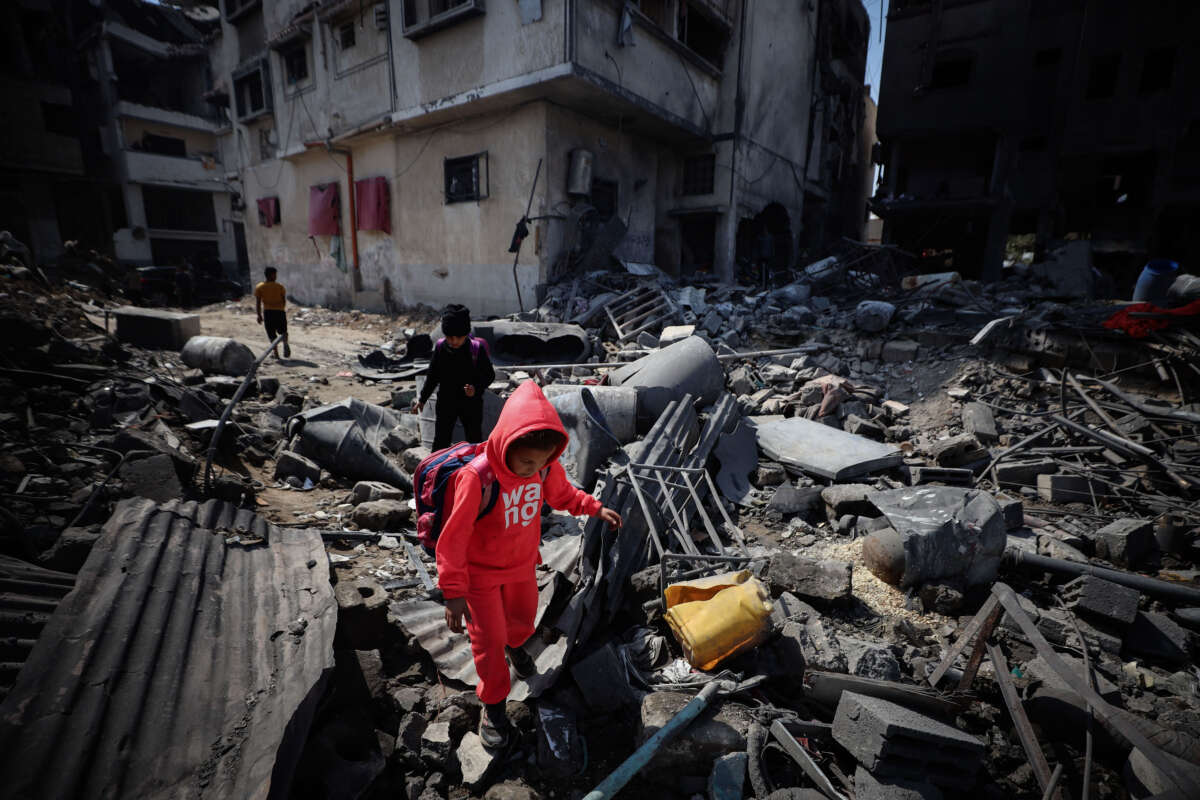 People look through the rubble in a house after an Israeli strike in Gaza City on March 18, 2025.