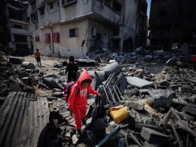 People look through the rubble in a house after an Israeli strike in Gaza City on March 18, 2025.