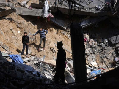 eople search for survivors in the rubble of a building destroyed in an overnight Israeli military strike in Jabaliya, in the northern Gaza Strip on March 18, 2025.