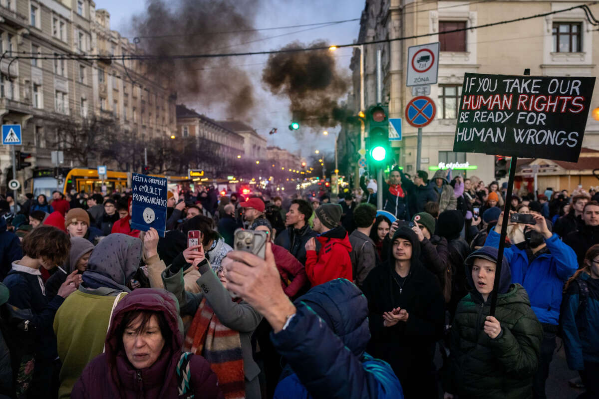 Demonstrators hold banners during a protest on March 18, 2025, in Budapest, Hungary.