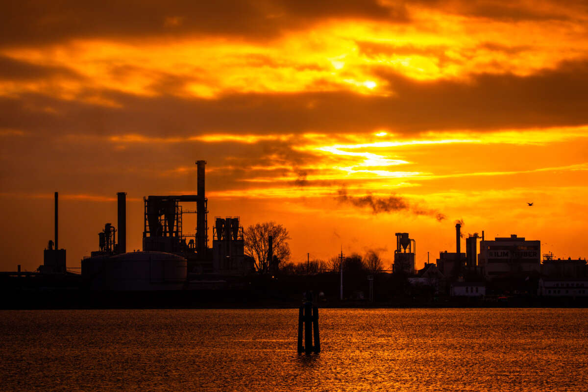 a wood-processing industrial plant against the setting sun