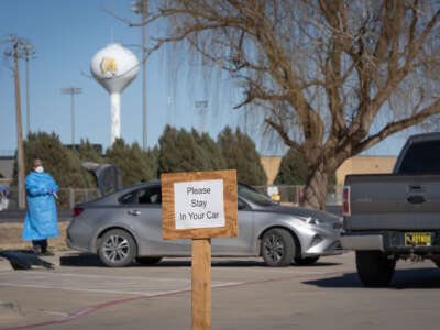 Signs point the way to measles testing in the parking lot of the Seminole Hospital District across from Wigwam Stadium on February 27, 2025, in Seminole, Texas.