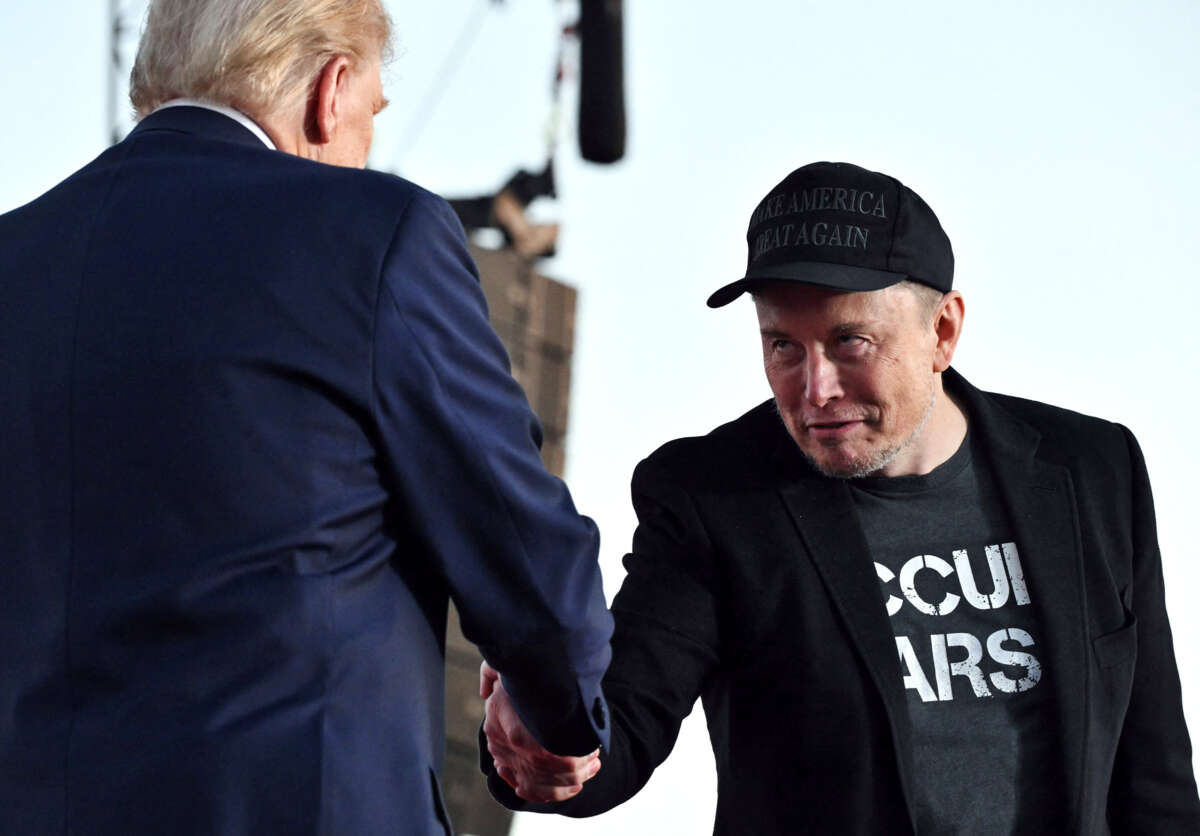 Elon Musk, looking deeply untrustworthy, shakes Donald Trump's hand as they both stand at the podium of a campaign event