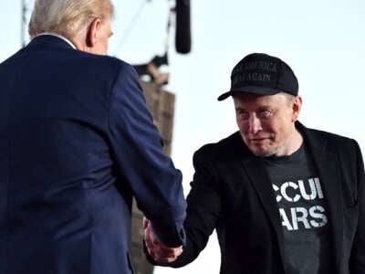 Elon Musk, looking deeply untrustworthy, shakes Donald Trump's hand as they both stand at the podium of a campaign event