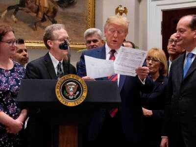 President Trump looks at a medical bill as he speaks during event on ending surprise medical billing at the White House in Washington, D.C., on May 9, 2019.