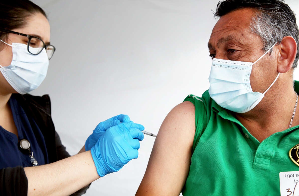 Registered nurse Angelea Smeal administers a dose of the Johnson & Johnson COVID-19 vaccine to a man at the St. John's Well Child and Family Center clinic targeting immigrant community members on March 25, 2021, in Los Angeles, California.