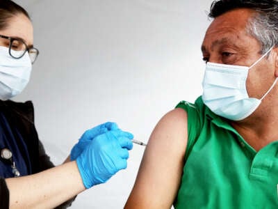 Registered nurse Angelea Smeal administers a dose of the Johnson & Johnson COVID-19 vaccine to a man at the St. John's Well Child and Family Center clinic targeting immigrant community members on March 25, 2021, in Los Angeles, California.