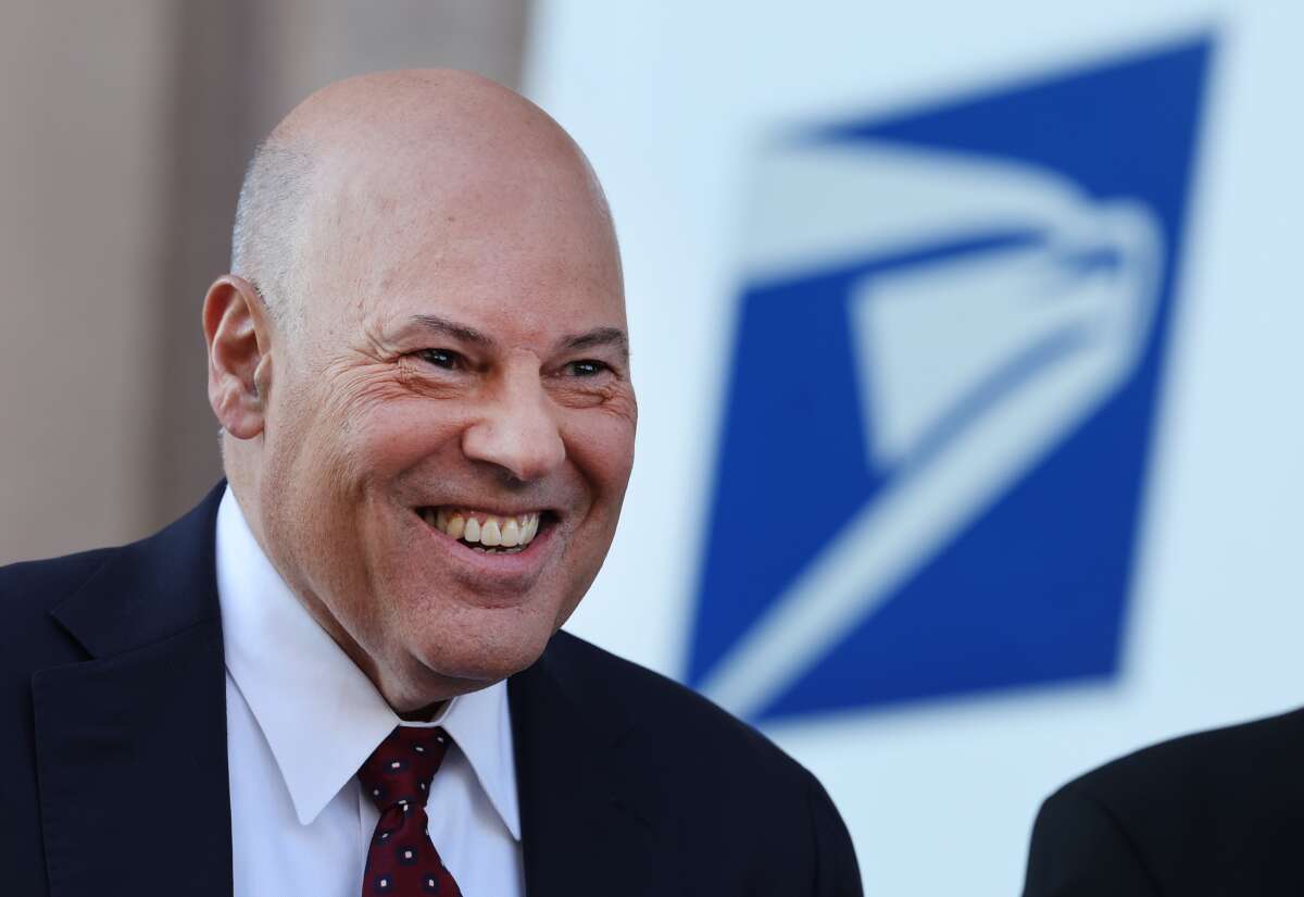 U.S. Postmaster General Louis DeJoy attends an event announcing the Postal Service's plan on implementing electric vehicles, at the Postal Service Headquarters on December 20, 2022, in Washington, D.C.