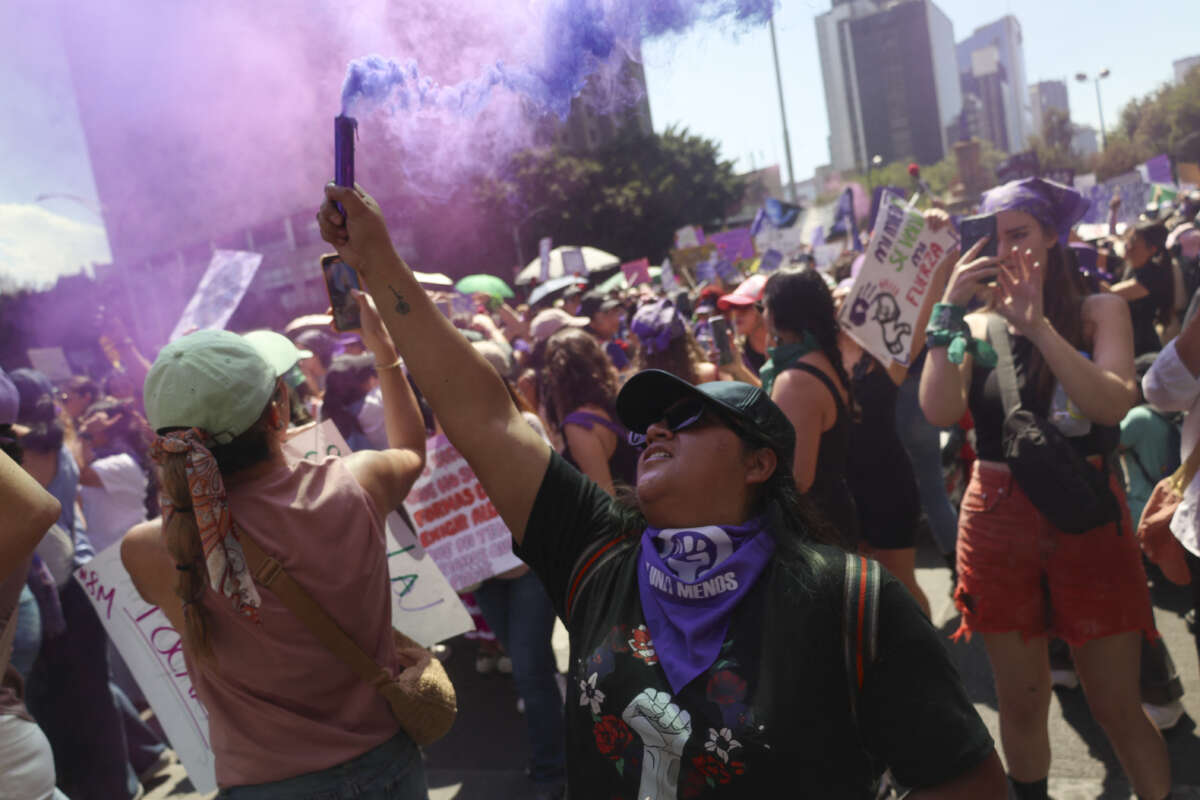 A demonstrator lights a flare during an International Women's Day march in Mexico City on March 8, 2025.