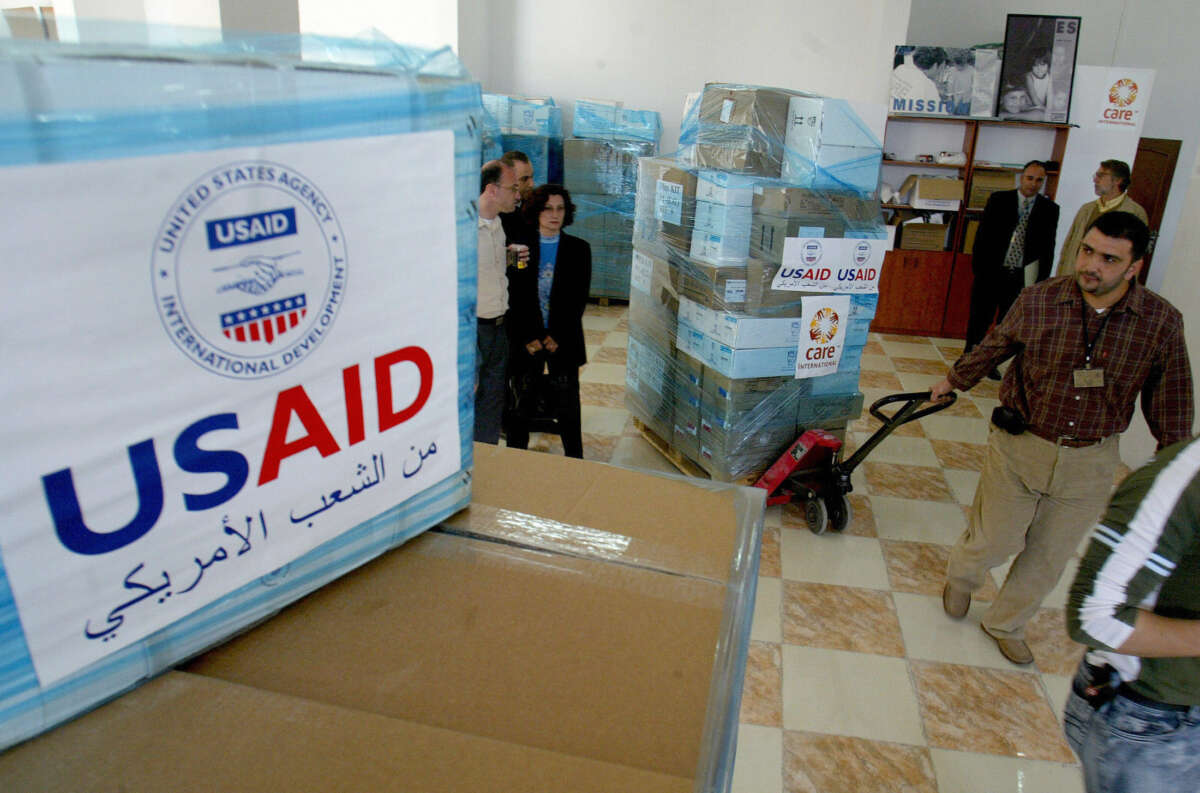 U.S. Agency for International Development employees are seen at the CARE international warehouse in the West Bank town of Ramallah, on May 10, 2006, as they ready to load two trucks with donated medical supplies to be sent to the Gaza Strip.