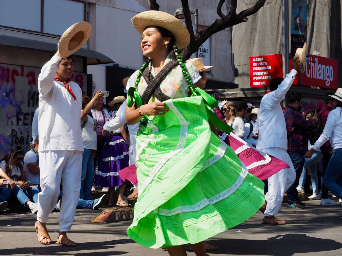 A dancer from a folkloric Indigenous dance troupe from Pochutla, Oaxaca performs on Juarez Avenue in Mexico City on Sunday, March 9, 2025.