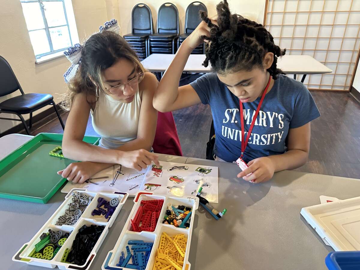 In a hands-on physics class, students build and test LEGO machines while exploring Newton’s Laws of Motion in action at For the Culture in San Antonio, Texas.