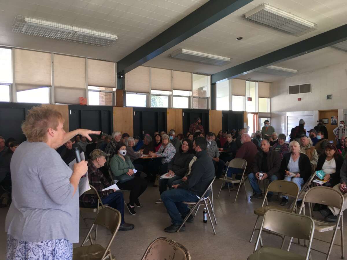 Following the Dixie Fire of 2021, the Indian Valley Collective meets for its monthly meeting in the cafeteria of Greenville Elementary School -- one of the few buildings in Greenville, California, to survive. These meetings are where community members share vital information about recovery efforts and new projects. Sue Weber (who wrote a piece in Red Flag Warning) is speaking.