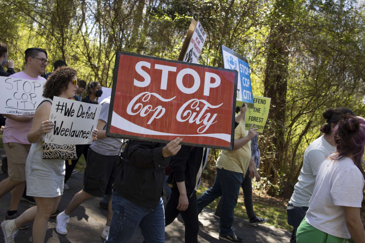 Environmental activists hold a rally and a march through the Atlanta Forest, a preserved forest Atlanta that is scheduled to be developed as a police training center, March 4, 2023 in Atlanta, Georgia.