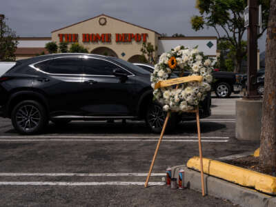 A wreath for the late Carlos Roberto Montoya, a 52-year-old man from Guatemala, is placed in the parking lot of Home Depot on August 16, 2025 in Monrovia, California.