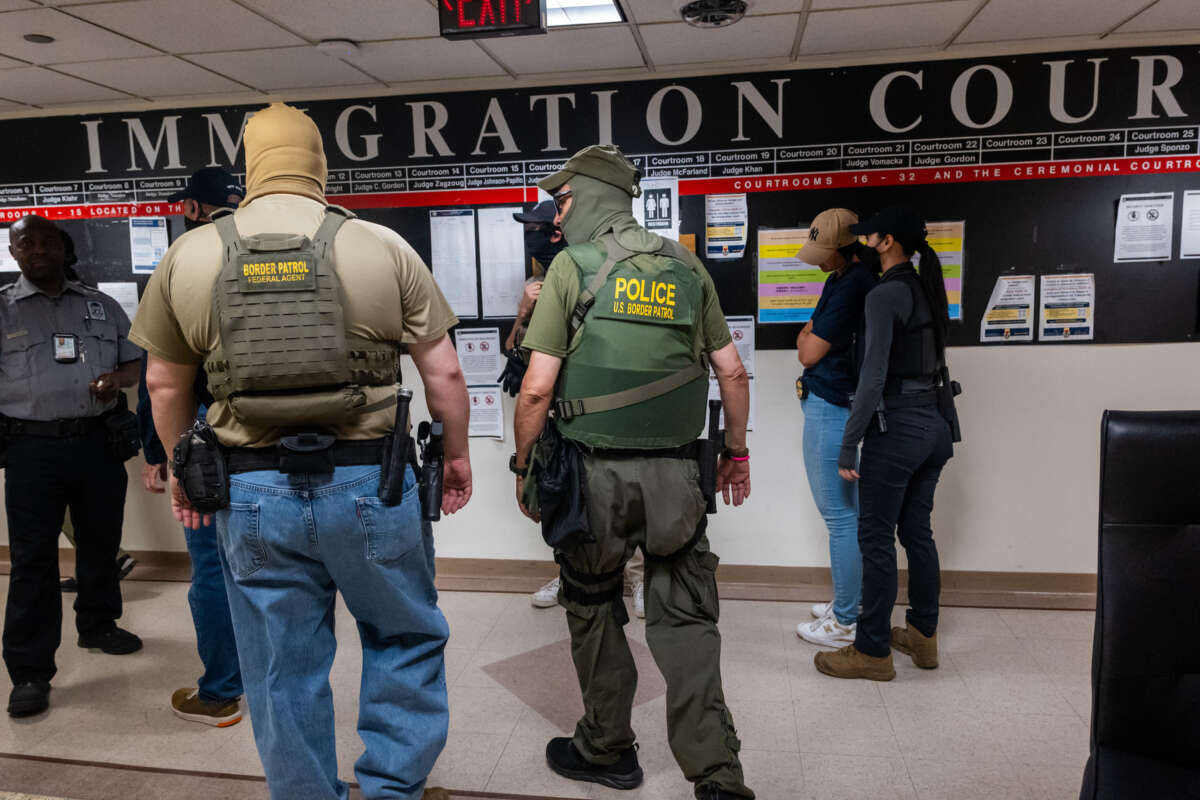 Federal agents, including members of ICE, patrol the halls of immigration court in New York City.