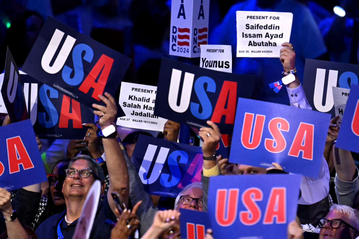 Attendees hold up signs with the names of people who died in the Gaza war on the second day of the Democratic National Convention (DNC) at the United Center in Chicago, Illinois, on August 20, 2024.